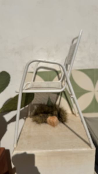 2 metal chairs with typical perforated sheet metal