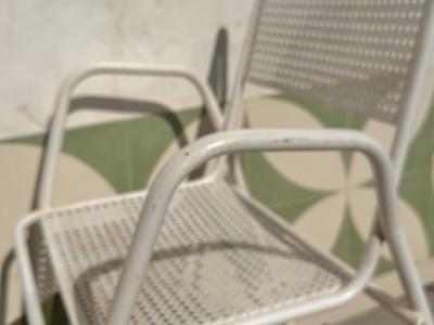 2 metal chairs with typical perforated sheet metal