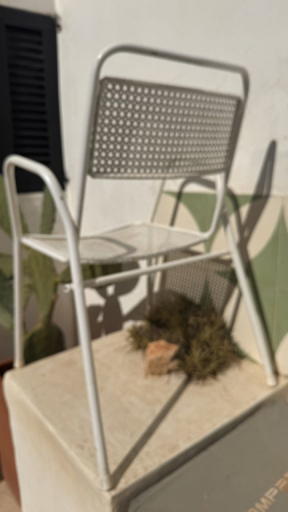 2 metal chairs with typical perforated sheet metal