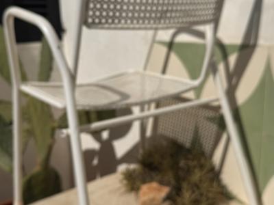 2 metal chairs with typical perforated sheet metal