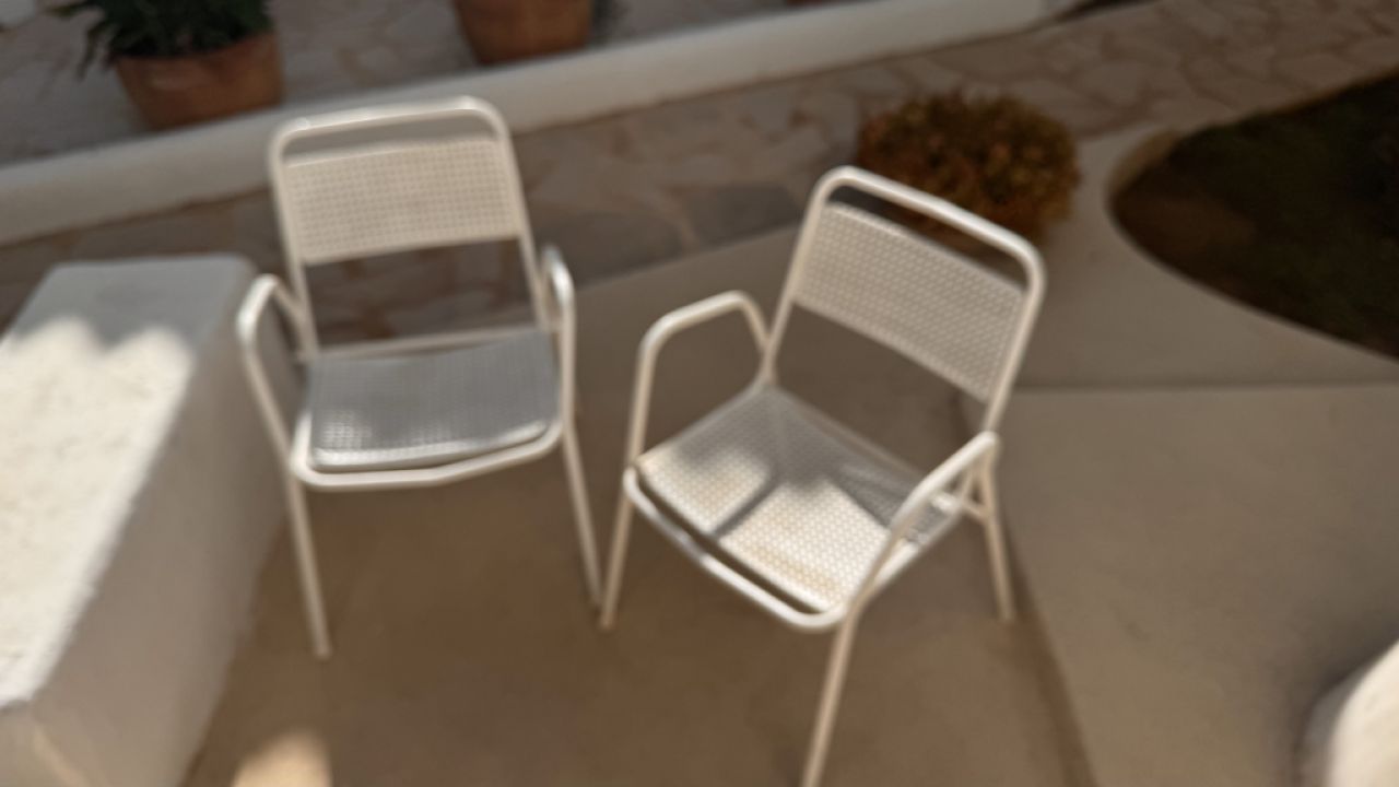 2 metal chairs with typical perforated sheet metal