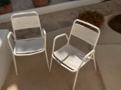 2 metal chairs with typical perforated sheet metal