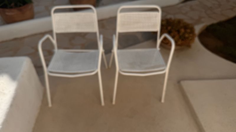 2 metal chairs with typical perforated sheet metal
