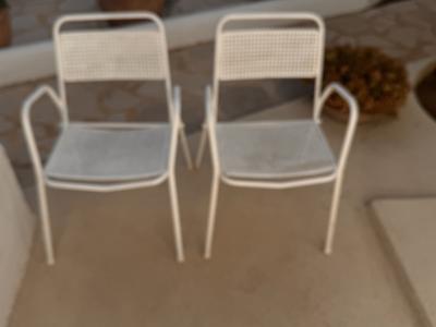 2 metal chairs with typical perforated sheet metal