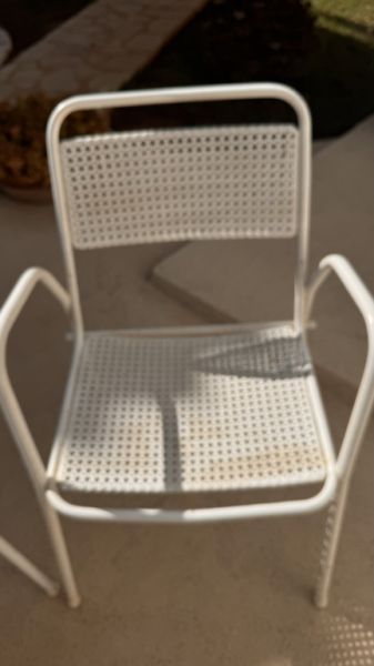 2 metal chairs with typical perforated sheet metal