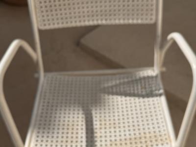 2 metal chairs with typical perforated sheet metal