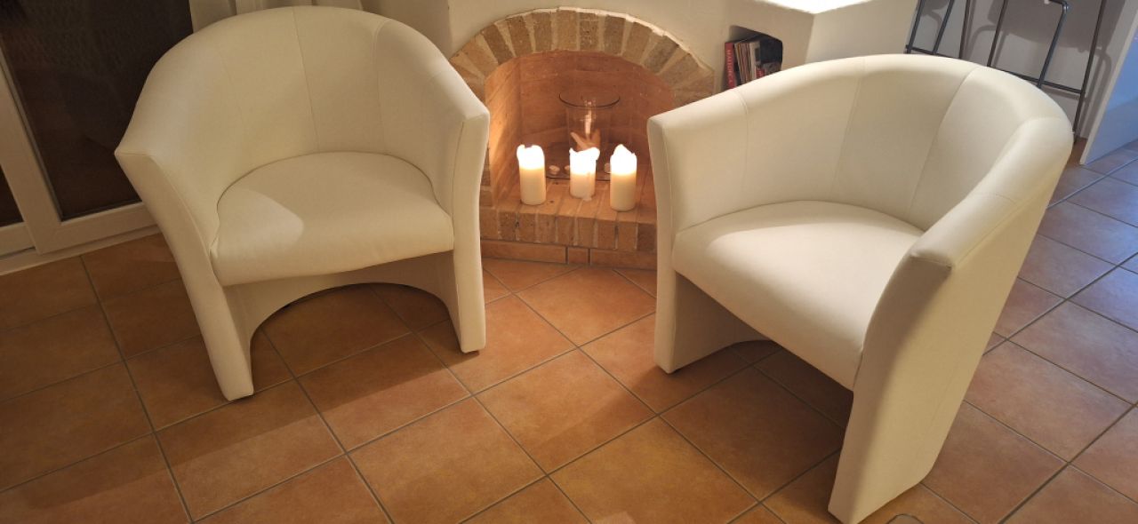 White faux leather cocktail armchairs