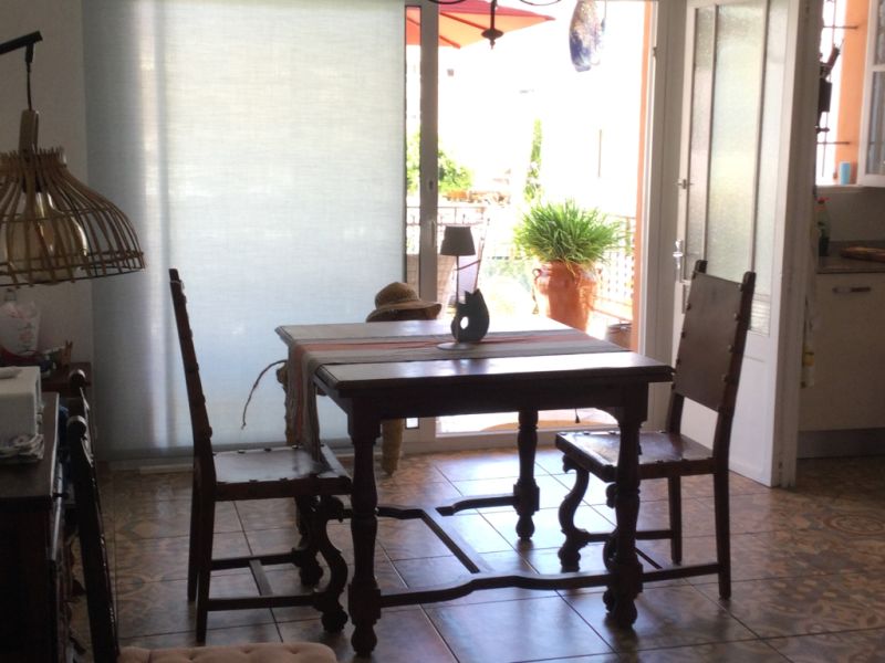 Wooden dining table with two leather chairs