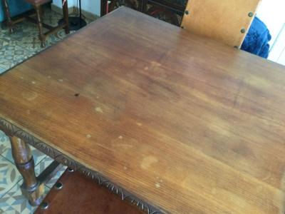 Wooden dining table with two leather chairs