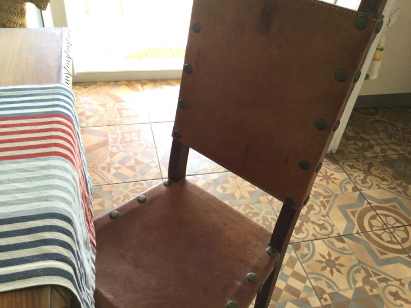 Wooden dining table with two leather chairs