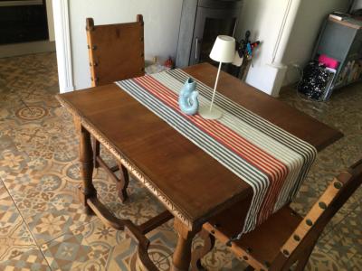 Wooden dining table with two leather chairs