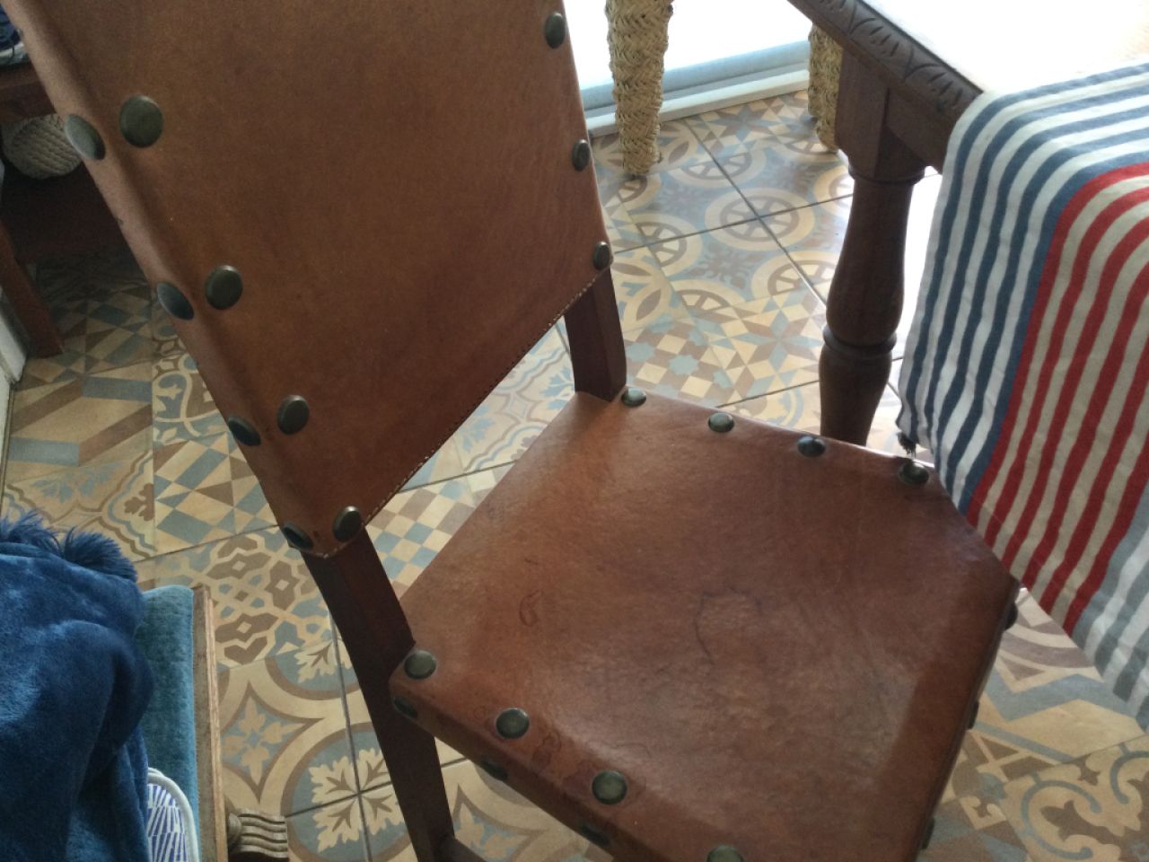 Wooden dining table with two leather chairs