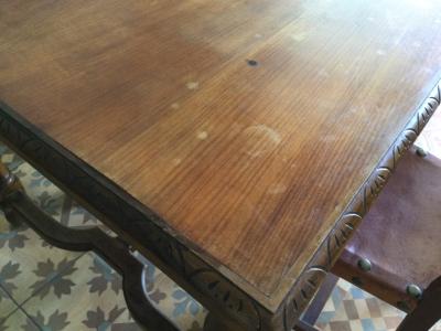 Wooden dining table with two leather chairs