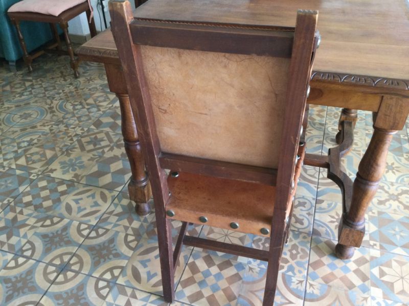 Wooden dining table with two leather chairs