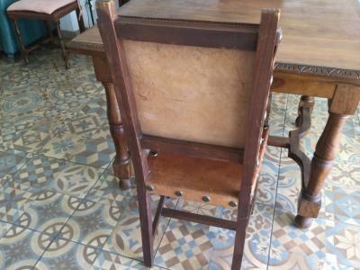 Wooden dining table with two leather chairs