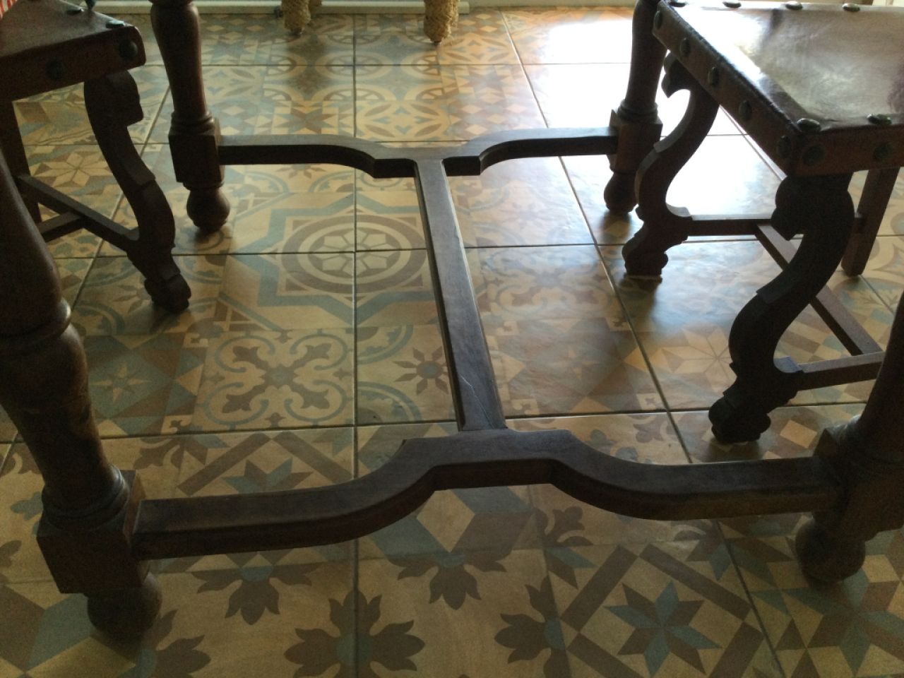 Wooden dining table with two leather chairs