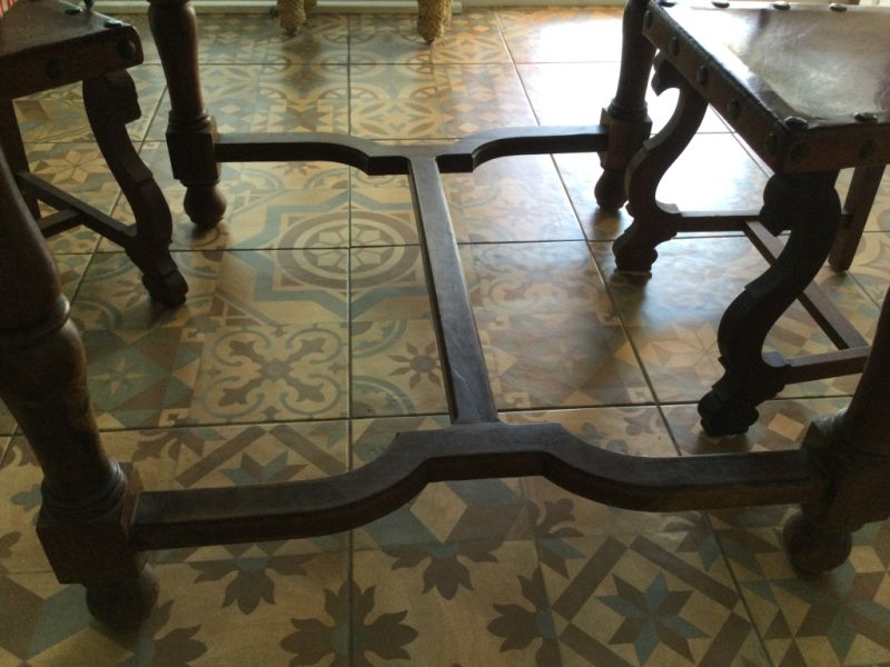 Wooden dining table with two leather chairs