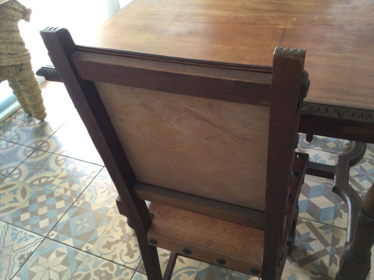 Wooden dining table with two leather chairs