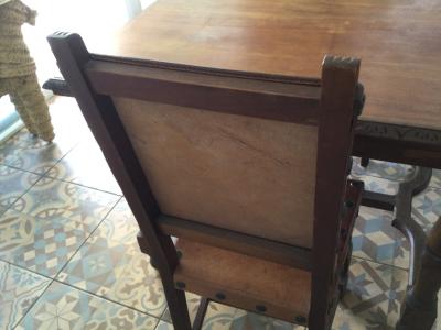 Wooden dining table with two leather chairs
