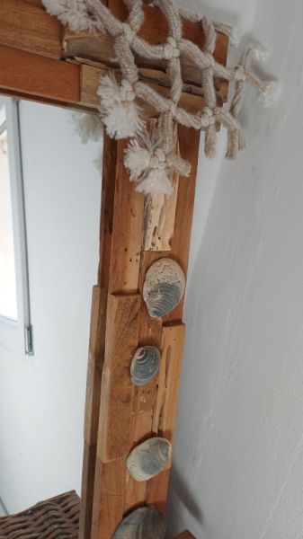 Mirror with wooden frame, driftwood and shells