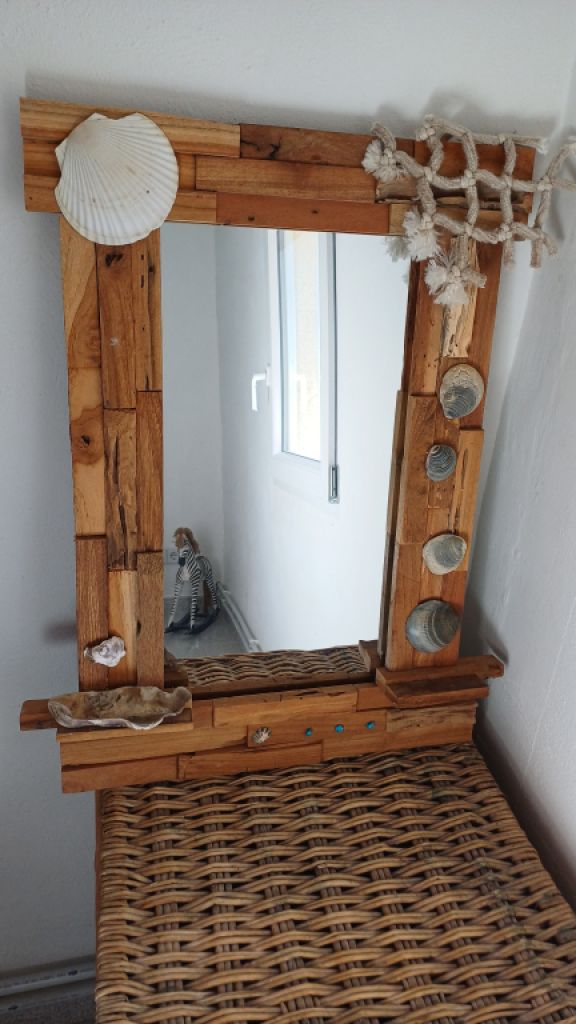 Mirror with wooden frame, driftwood and shells